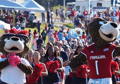 Southpaw and Ms. Pawla cheering at the Jag Walk before a football game.