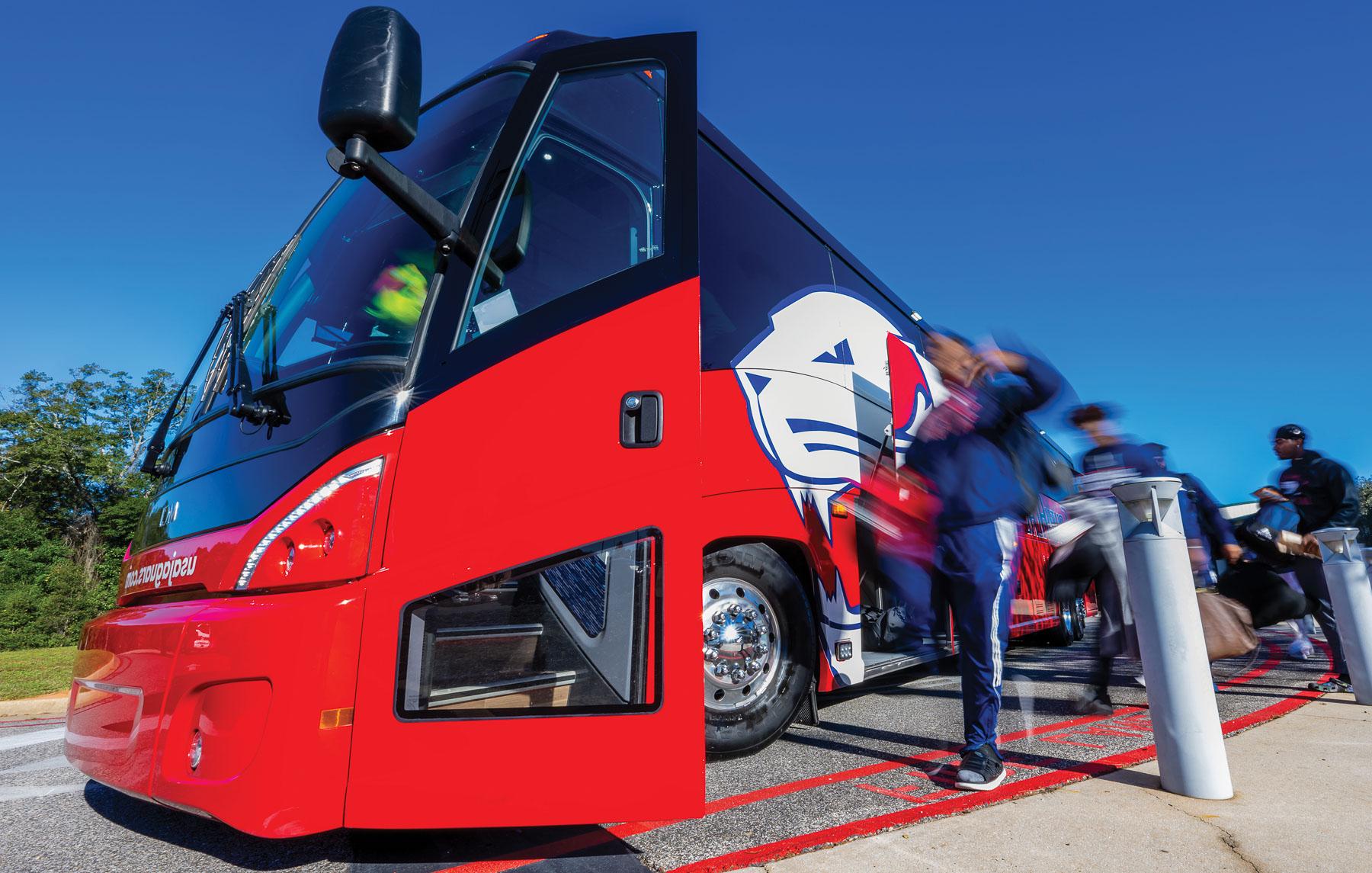 Four red and blue coach buses play an integral role in transporting University of South Alabama athletics teams. The buses are also used to transport high school students to campus for Jag Days tours. 